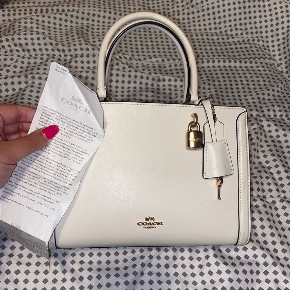 Cream coach bag with shoulder strap included